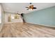 Large living room with wood-look floors, ceiling fan, and staircase at 1006 Vista Cay Ct, Brandon, FL 33511