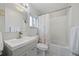 Clean bathroom with a shower/tub combo, white tile, and updated vanity at 3000 21St S Ave, St Petersburg, FL 33712