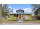 Charming bungalow with a red door, unique exterior, and landscaped yard at 3000 21St S Ave, St Petersburg, FL 33712