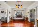 Hallway with hardwood floors and antique bench; view to living room and kitchen at 3000 21St S Ave, St Petersburg, FL 33712