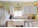 Kitchen with white cabinets, granite countertops, and a farmhouse sink at 3000 21St S Ave, St Petersburg, FL 33712