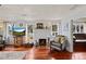 Living room with hardwood floors, fireplace, and view into another room at 3000 21St S Ave, St Petersburg, FL 33712