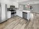 Modern kitchen with white cabinets, stainless steel appliances, and quartz countertops at 5466 9Th N Ave, St Petersburg, FL 33710