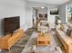 Bright living room featuring hardwood floors, comfortable seating, and a view to the dining area at 5466 9Th N Ave, St Petersburg, FL 33710