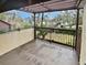 Private balcony with covered pergola and view of trees at 705 S Village N Dr # 205, St Petersburg, FL 33716