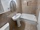 Clean bathroom with pedestal sink and bathtub at 705 S Village N Dr # 205, St Petersburg, FL 33716