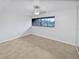 Bright bedroom with tile floors and a large window at 705 S Village N Dr # 205, St Petersburg, FL 33716