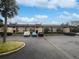 Condo building exterior with parking and landscaping at 705 S Village N Dr # 205, St Petersburg, FL 33716