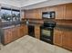 Updated kitchen with wood cabinets and black appliances at 705 S Village N Dr # 205, St Petersburg, FL 33716