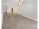Bright living room with tile floors and view to kitchen at 705 S Village N Dr # 205, St Petersburg, FL 33716
