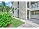 Condo building exterior with lush landscaping and unique architectural details at 4455 Duhme Rd # 205, St Petersburg, FL 33708