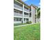 Condo building exterior with well-maintained landscaping at 4455 Duhme Rd # 205, St Petersburg, FL 33708