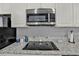 Granite countertop with stainless steel appliances at 4455 Duhme Rd # 205, St Petersburg, FL 33708