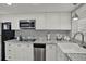 White kitchen cabinets and stainless steel appliances at 4455 Duhme Rd # 205, St Petersburg, FL 33708