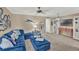 Living room with blue sectional sofa, coastal decor, and ottomans at 4455 Duhme Rd # 205, St Petersburg, FL 33708