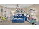 Living room with blue sectional sofa and coastal decor at 4455 Duhme Rd # 205, St Petersburg, FL 33708