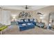 Living room with blue sectional sofa, coastal decor, and ottomans at 4455 Duhme Rd # 205, St Petersburg, FL 33708