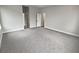 Large bedroom with grey carpet and access to other rooms at 4739 Butler National Dr, Wesley Chapel, FL 33543