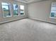 Spacious bedroom with grey carpet and large windows at 4739 Butler National Dr, Wesley Chapel, FL 33543