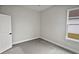 Bright bedroom featuring a window with natural light and grey carpeting at 4739 Butler National Dr, Wesley Chapel, FL 33543