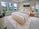 Bright main bedroom features a light wood platform bed and water views at 4739 Butler National Dr, Wesley Chapel, FL 33543