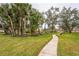 Curving path through a lush, green community landscape at 5711 Avista Dr # 4110, Sarasota, FL 34243