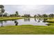 Serene pond view with lush landscaping and golf course at 5711 Avista Dr # 4110, Sarasota, FL 34243