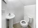 Small half bathroom with pedestal sink and toilet at 9416 Citrus Glen Pl, Tampa, FL 33618