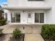 Front entrance of townhome, showing patio and landscaping at 9416 Citrus Glen Pl, Tampa, FL 33618