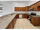 Modern kitchen with granite countertops and wood cabinets at 9416 Citrus Glen Pl, Tampa, FL 33618