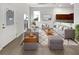 Bright living room with gray sofas, wooden coffee table, and large windows at 9416 Citrus Glen Pl, Tampa, FL 33618