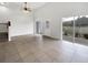 Open living area with tile floor and access to the back patio at 9416 Citrus Glen Pl, Tampa, FL 33618