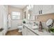 Bathroom with granite countertop, white cabinets, and a shower at 105 17Th Ne Ave, St Petersburg, FL 33704