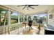 Sunroom office with a view, featuring a ceiling fan and glass block accents at 105 17Th Ne Ave, St Petersburg, FL 33704