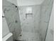 Updated bathroom with marble shower and hexagon tile floor at 6320 Cedar St Ne, St Petersburg, FL 33702