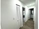 Clean hallway with linen closet and doors to bedrooms and bathrooms at 6320 Cedar St Ne, St Petersburg, FL 33702