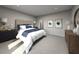 Spacious bedroom with plush bed, neutral color palette and modern nightstands at 1867 Draughton Dr, Zephyrhills, FL 33541