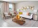 Living room with white sofa, wood coffee table, and decorative wall art at 1868 Brekey Way, Zephyrhills, FL 33541