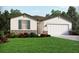 One-story home with landscaped yard, attached garage, and stone accents at 1886 Draughton Dr, Zephyrhills, FL 33541