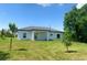 New construction home with grassy backyard and covered patio at 2827 Soprano Ln, North Port, FL 34286