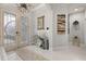 Bright entryway with double doors, decorative console table, and stylish wall art at 6720 The Masters Ave, Lakewood Ranch, FL 34202