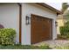 Brown garage door with decorative windows and black lanterns at 6720 The Masters Ave, Lakewood Ranch, FL 34202