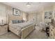 Luxurious main bedroom with king-size bed, stylish decor, and private access at 6720 The Masters Ave, Lakewood Ranch, FL 34202