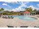 Community pool with mushroom fountain and lounge chairs at 6720 The Masters Ave, Lakewood Ranch, FL 34202