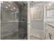 Large walk-in shower with glass enclosure and gray tile at 6720 The Masters Ave, Lakewood Ranch, FL 34202