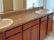 Double vanity bathroom with granite countertop and wood cabinets at 562 Vista Ridge Dr, Ruskin, FL 33570