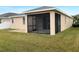 Covered screened patio with concrete slab and grassy backyard at 562 Vista Ridge Dr, Ruskin, FL 33570
