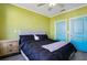 Bright bedroom with lime green walls and a queen bed at 4221 W Spruce St # 1407, Tampa, FL 33607