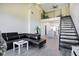 Open living room with loft and black sectional at 4221 W Spruce St # 1407, Tampa, FL 33607