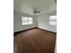 Spacious bedroom with brown carpet and large window at 732 Riverside Dr, Tarpon Springs, FL 34689